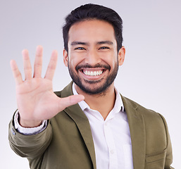 Image showing Portrait, smile and Asian man with stop, hand and communication against grey studio background. Face Japanese male or guy with gesture for warning, sign language and welcome with opportunity or smile