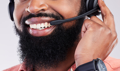 Image showing Closeup, consultant and black man with headset, telemarketing and explain process against a studio background. Zoom, male employee and happy agent with headphones, customer service and tech support