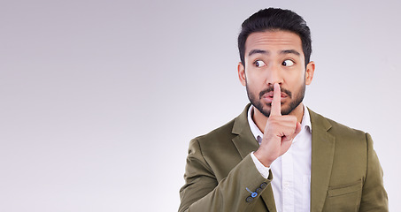 Image showing Business man, mockup and finger on lips in studio, white background and privacy secret. Male employee, silence and shush for quiet sign, gossip and whisper emoji of corporate mystery, news or mock up