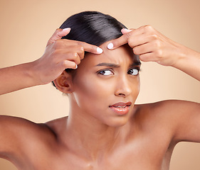 Image showing Indian woman, pimple and skincare in studio with face, cosmetics and stress by background. Model girl, young asian and hand on forehead for cosmetic wellness with worry, skin acne or facial aesthetic