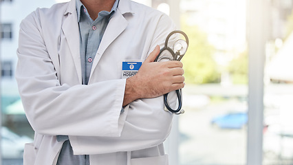 Image showing Doctor, healthcare and professional man, arms crossed and medical innovation, leader and medicine mission. Health, stethoscope and cardiology expert, confident surgeon and male physician in clinic