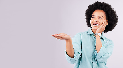Image showing Mockup, product placement and black woman with hands in studio for advertising, marketing and branding. Happy, smile and isolated girl with gesture on white background for show, choice and promotion