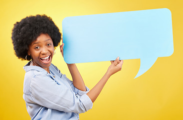 Image showing Excited, speech bubble and portrait of black woman in studio with mockup for social media, advertising or space. Face, paper and happy lady with billboard for news or poster on yellow background