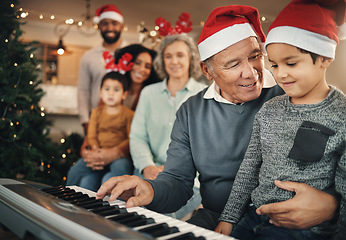 Image showing Family, christmas and grandfather with grandchild on piano for learning, teaching and bond in their home. Music, instrument and retired pianist performing for kids and parents in festive celebration