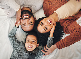 Image showing Family, laughing and top view portrait on bed in bedroom, bonding and care in home. Love, smile and happy mother, comic father and funny boy child playing, having fun and enjoying joke time together.