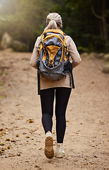 Image showing Girl hiking, back view or woman in nature, forest or wilderness for a trekking adventure. Freedom, backpack healthy female hiker walking in a natural park or woods for exercise or wellness on holiday