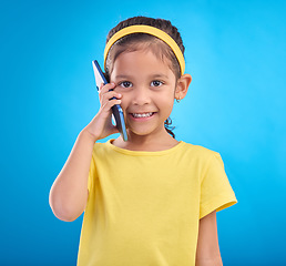 Image showing Phone call, smile and portrait of child on blue background for talking, speaking and chatting online. Technology, communication mockup and face of happy girl in conversation on smartphone in studio