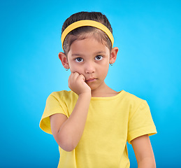 Image showing Mockup, portrait and girl with fear, afraid and mental health issue on blue studio background. Face, female kid and child with anxiety, nervous and scared with young person, panic reaction of anxiety