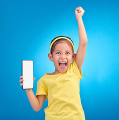 Image showing Phone, winner and child with mockup screen on blue background for social media, website and mobile app. Advertising, brand space and girl happy, excited and celebration for success, goals and winning