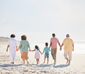 Image showing Family at beach, holding hands and generations outdoor, people walk on sand with grandparents, parents and kids. Together, support and trust, travel to Bali with love, care and bond with back view