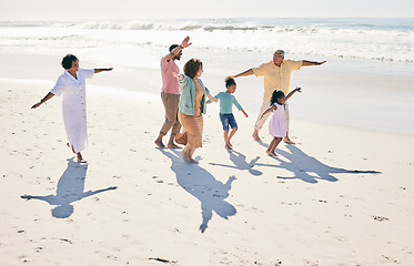 Image showing Family have fun on beach, freedom and generations with travel and grandparents with parents and kids. Adventure, happy people outdoor and carefree, excited running and playful, happiness on vacation