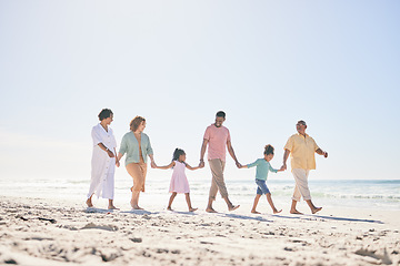 Image showing Happy family walking on beach holding hands with children for love, bonding and quality time together. Relax, smile and kids with mom, dad and grandparents on holiday, summer vacation and weekend