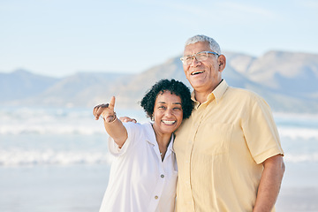 Image showing Old couple at beach, hug and travel with smile, retirement and love outdoor, vacation with view and relax in nature. Peace, zen and man with woman pointing, happiness and wellness in Bali on holiday
