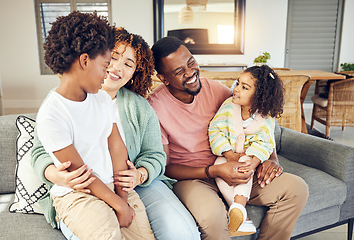 Image showing Happy family, embrace and laugh on a sofa, cheerful and smile while bonding and relax in their home. Laughing, children and parents on couch together, hug and loving in a living room on weekend