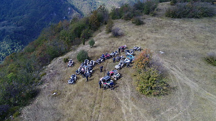 Image showing Aerial drone view of ATV quads on a dirt trail in forests. Off-road group team club enthusiasts having fun while driving countryside roads.