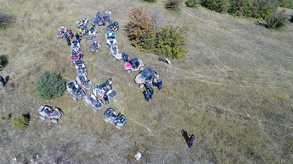 Image showing Aerial drone view of ATV quads on a dirt trail in forests. Off-road group team club enthusiasts having fun while driving countryside roads.