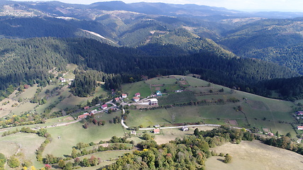 Image showing Aerial drone view of ATV quads on a dirt trail in forests. Off-road group team club enthusiasts having fun while driving countryside roads.