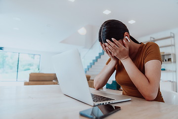 Image showing Disappointed woman sitting in living room using laptop. Business concept