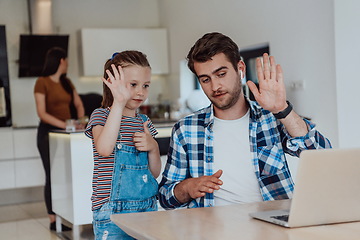 Image showing Father and daughter in modern house talking together on laptop with their family during holidays. The life of a modern family