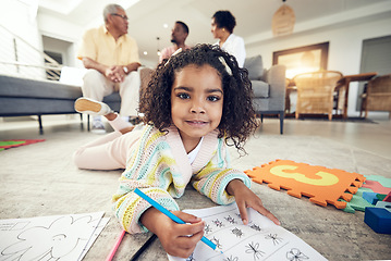 Image showing Child portrait, coloring homework and pencil art of a girl lying on a living room carpet with family at home. House, color drawing learning and creative development of young kid with a school book