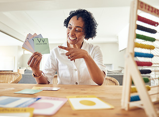 Image showing Woman, smile and alphabet for learning letters, words or education with abacus and shapes on table at home. Happy female teacher, tutor or educator smiling holding and pointing at letter cards