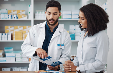 Image showing Pharmacy, reading and brochure with people in store for medical, information and shopping. Healthcare, wellness and expert with man and woman in drugs dispensary for medicine, product and seller