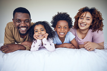 Image showing Black family, portrait and relax in bed, happy and smile while bonding in their home together. Face, children and parents waking up in bedroom, lying and resting, having fun and enjoying the weekend