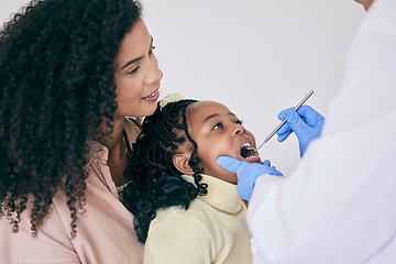 Image showing Children, mother and a girl at the dentist for oral hygiene or a checkup to search for a cavity or gum disease. Kids, dental or healthcare with a female child and mother at the orthodontist