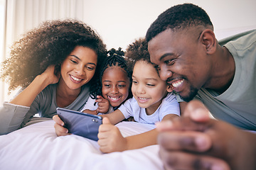 Image showing Phone, bedroom and family watching a video on social media, mobile app or the internet together. Happy, bonding and African children streaming a movie or film on cellphone with their parents at home.