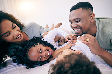 Image showing Laugh, tickle and morning with black family in bedroom for wake up, bonding and affectionate. Weekend, smile and care with parents and children at home for playful, funny and free time together