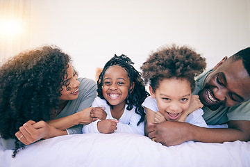 Image showing Happy, laugh and morning with black family in bedroom for wake up, bonding and affectionate. Weekend, smile and care with parents and children at home for playful, funny and free time together