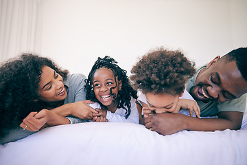 Image showing Laugh, relax and morning with black family in bedroom for wake up, bonding and affectionate. Weekend, smile and care with parents and children at home for playful, funny and free time together