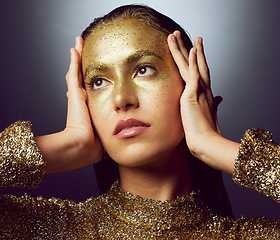 Image showing Glitter, gold and makeup with woman in studio for fashion, beauty and creative art. Glamour, trendy and cosmetics with female isolated on black background for luxury, elegance and shimmer sparkles