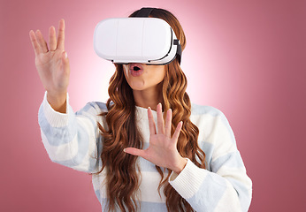 Image showing Virtual reality, metaverse and innovation with a woman using a headset to access the virtual world of gaming. AI, 3D and VR with a female gamer in studio on a pink background using future technology