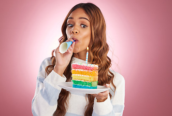 Image showing Happy, cake and celebration with woman in studio for birthday, party and event. Rainbow, dessert and cheering with young female isolated on pink background for food, happiness and festive treat