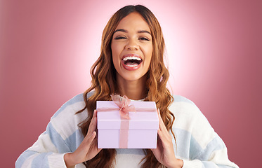 Image showing Woman, gift and box in studio portrait with happiness, surprise and celebration by gradient background. Student girl, young and happy with present package, excited face and celebrate for birthday