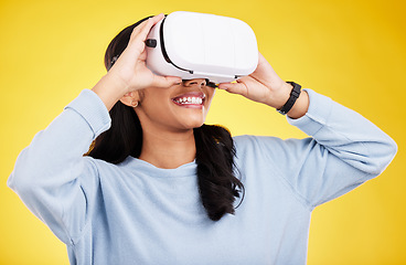 Image showing Woman with VR goggles, smile and experience in metaverse, digital world and futuristic on yellow studio background. Virtual reality, technology and UX, happiness and cyber space with gaming