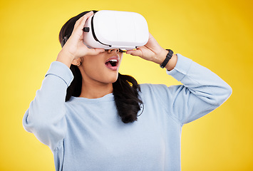 Image showing Woman with VR goggles, surprise and experience in metaverse, digital world and futuristic on yellow studio background. Virtual reality, technology and UX, wow expression and cyber space with gaming