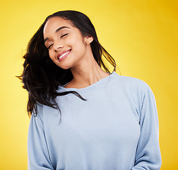 Image showing Young woman, hair and beauty, happy and satisfaction with gen z, fashion on yellow studio background. Happiness, youth and Indian female with smile, haircare and cosmetics with growth and shine