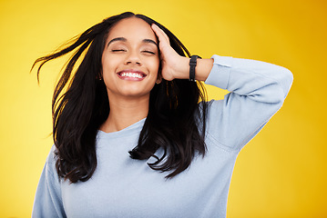 Image showing Happy, freedom and relief with a woman on a yellow background in studio feeling carefree or cheerful. Smile, relax and calm with an attractive young female posing eyes closed in a peaceful mood