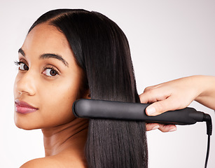 Image showing Woman flat iron and studio portrait with hair care, wellness and heat treatment by white background. Girl, model and healthy glow at hairdresser with electric tools for cosmetics, change and beauty