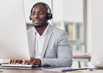 Image showing Call center, man and computer for typing with smile, reading and tech support with happiness at job. African telemarketing consultant, desktop pc and writing email for communication in customer care