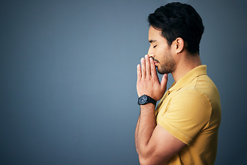 Image showing Pray, faith and mockup with a man in studio on a gray background asking god for a miracle or help. Trust, religion and spiritual with a handsome young male christian praying to jesus in belief