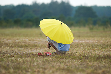 Image showing Man with yellow umbrella