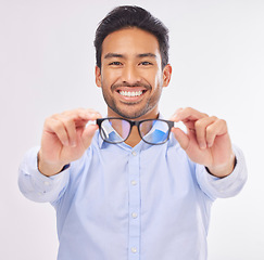 Image showing Glasses, vision portrait and man happy in studio for eye care, lens or frame isolated on a white background. Smile of asian male model show optometry eyewear brand in hands to check eyesight or focus