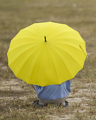 Image showing Man with yellow umbrella