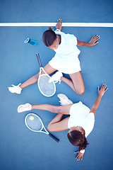 Image showing Top view, tennis and women tired, conversation and exhausted after match, training and happiness for sport. Female athletes, players or friends with rackets, workout or practice for healthy lifestyle