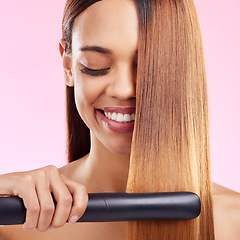 Image showing Happy, woman and hair straightener for beauty, salon treatment and girl on studio background. Female, lady and tool for cosmetics, texture and volume with grooming, shine and glow with smile and spa