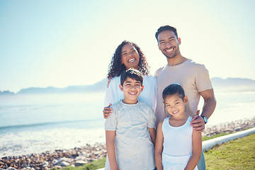 Image showing Happy, smile and portrait of family at beach for vacation, bonding and summer break. Holiday trip, travel and care with parents and children on field by sea for positive, affectionate or quality time