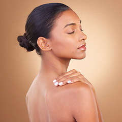 Image showing Beauty, wellness and back of Indian woman in studio with eyes closed for skincare, glowing and spa treatment. Salon, dermatology and girl rest on brown background with cosmetics, makeup and self love